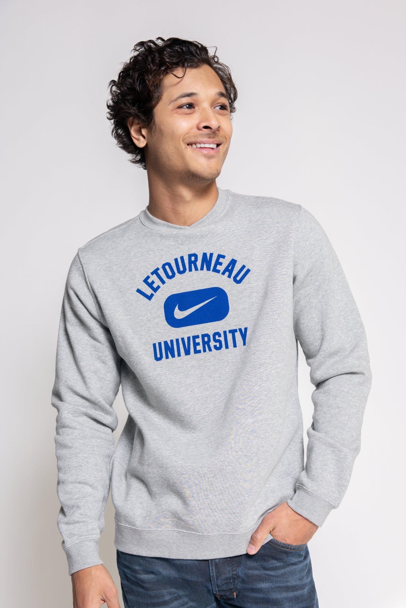 Person wearing a gray Nike sweatshirt with 'Letourneau University' printed on it.