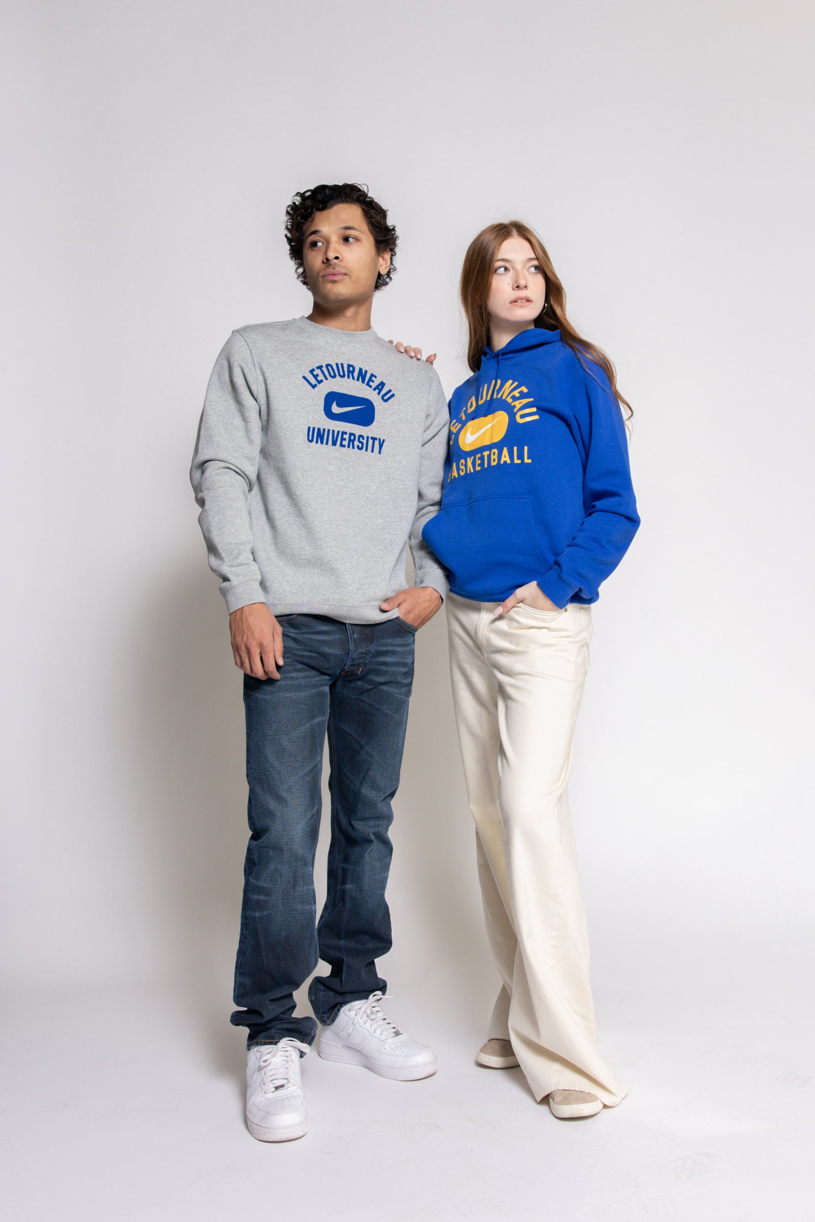 Two people wearing Letourneau sweatshirts with Nike branding on a white background