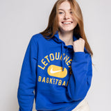 Person wearing a blue hoodie with 'Letourneau Basketball' text and a Nike logo on a plain background