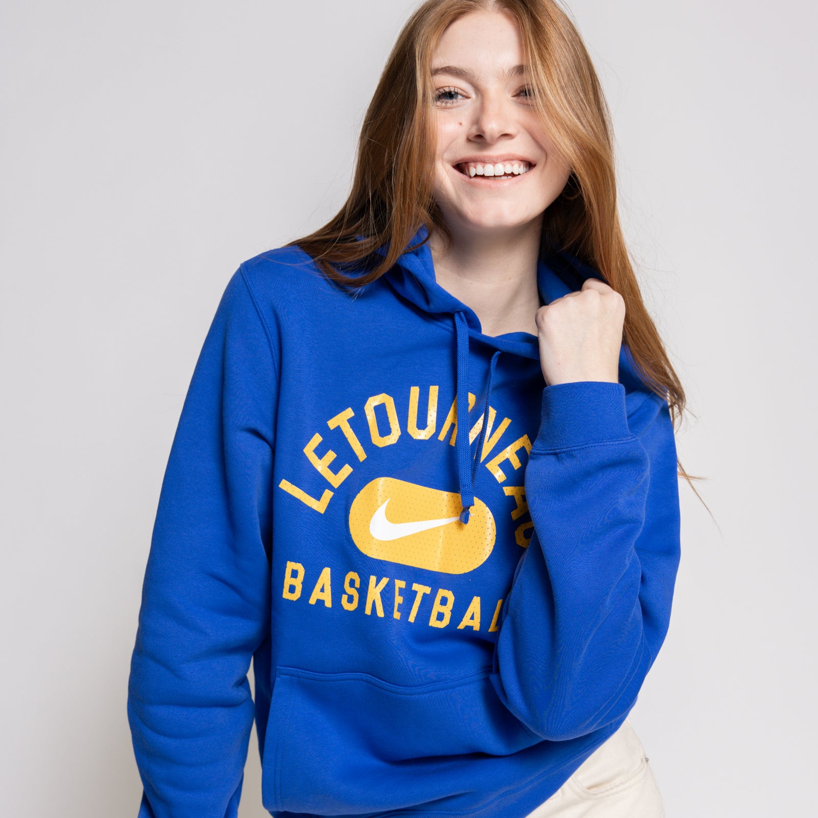 Person wearing a blue hoodie with 'Letourneau Basketball' text and a Nike logo on a plain background