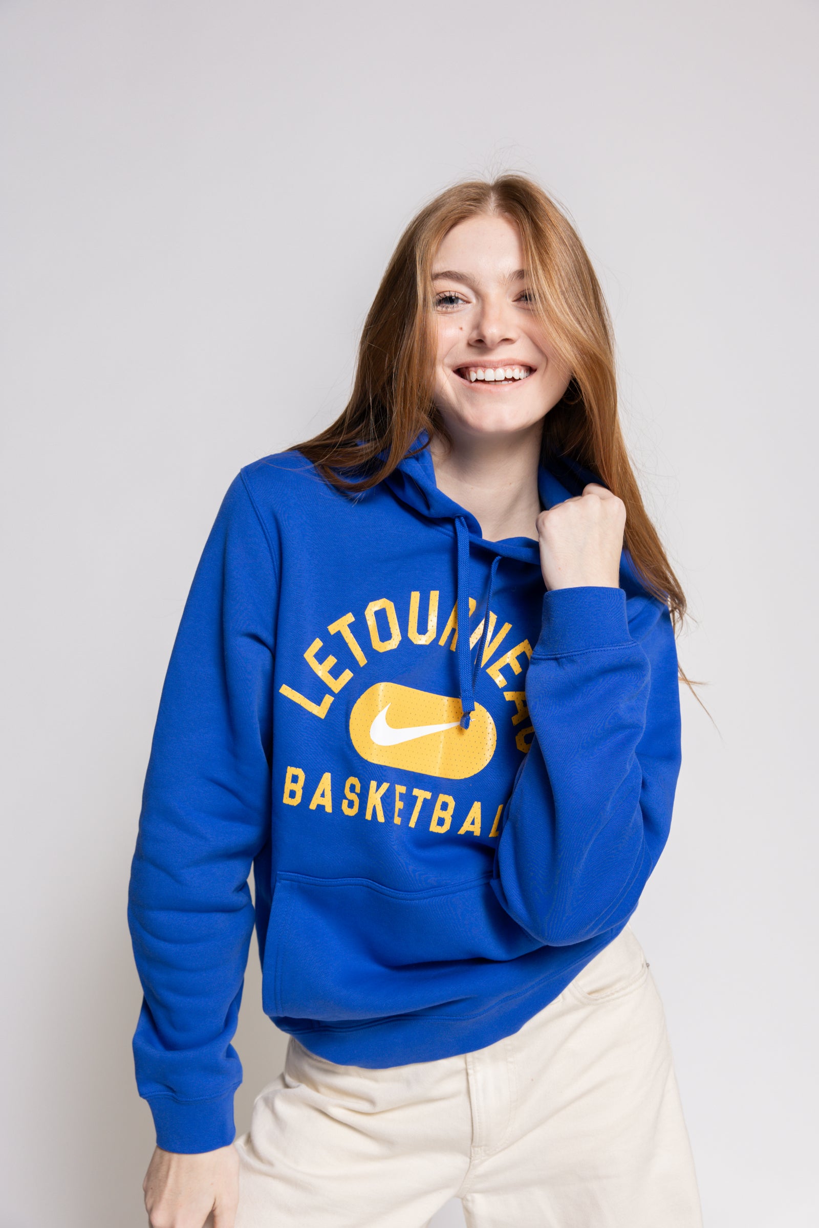 Person wearing a blue hoodie with 'Letourneau Basketball' text and a Nike logo on a plain background