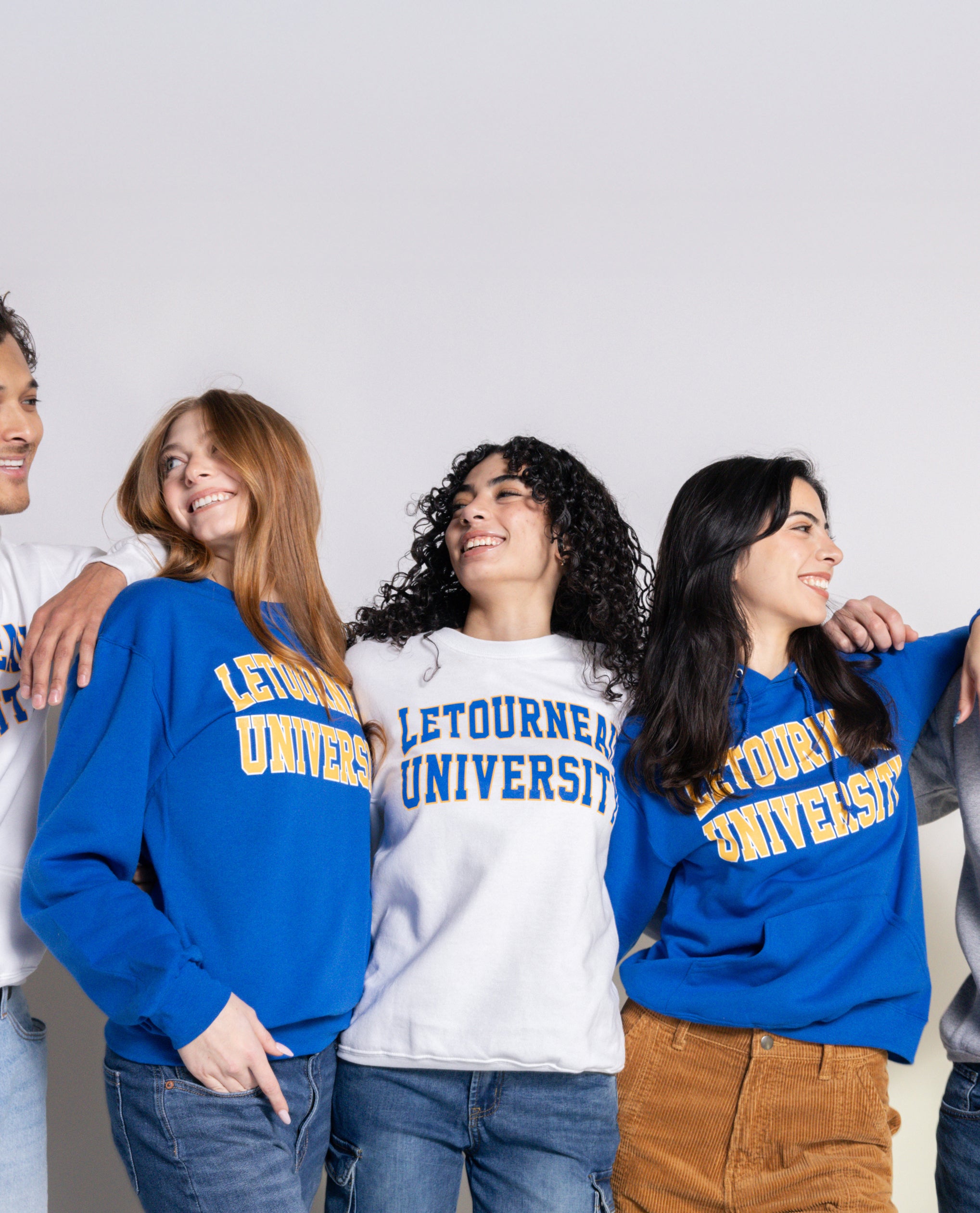 Group of people wearing Letourneau University sweatshirts against a plain background